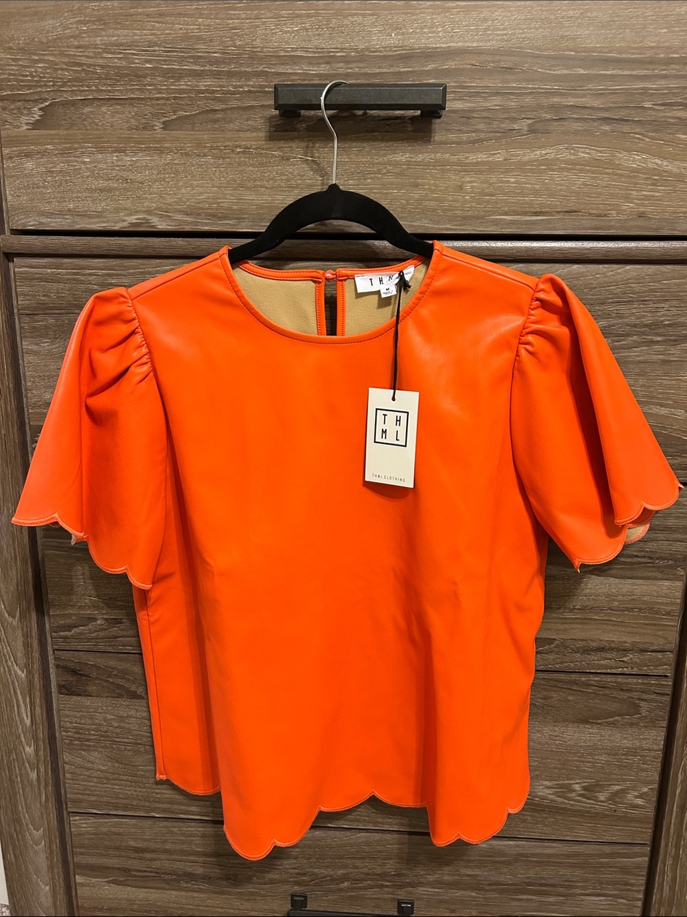 NWT THML Bright Orange Faux Leather Scalloped Flutter Sleeve Blouse. SZ M